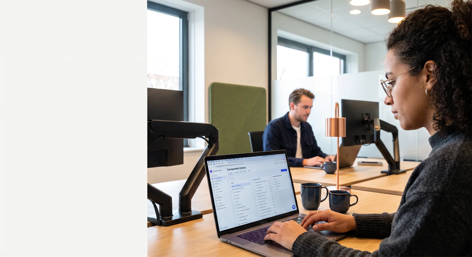 Next.js-developer werkt aan een frontend op een laptop aan een houten bureau in het Webkompanen-kantoor